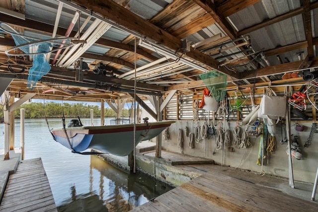 dock area featuring boat lift and a water view