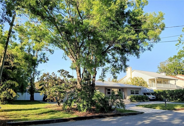 view of front of property featuring a front yard, stucco siding, and concrete driveway