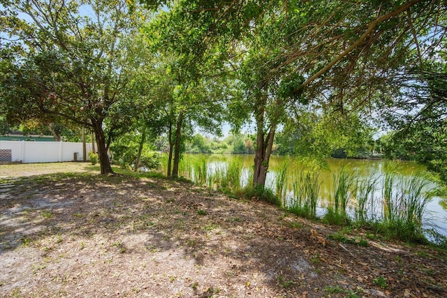 5050 68th Way N, Saint Petersburg, FL 33709 - view of yard with a water view and fence