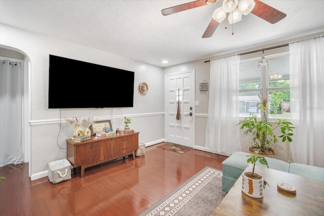 5050 68th Way N, Saint Petersburg, FL 33709 - living area with wood finished floors, baseboards, ceiling fan, and arched walkways