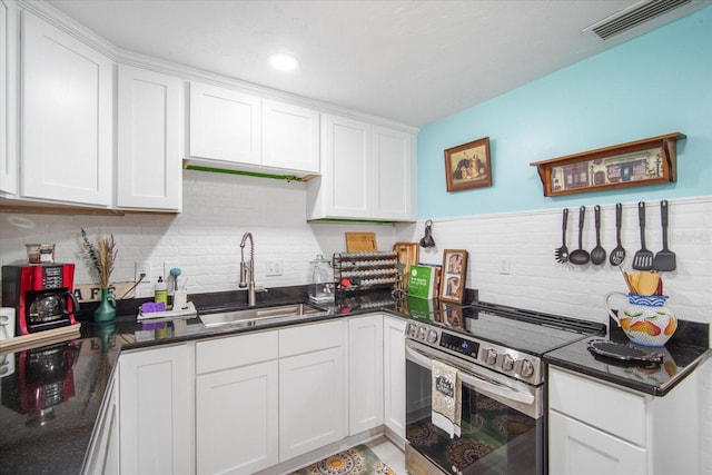 5050 68th Way N, Saint Petersburg, FL 33709 - kitchen featuring a sink, stainless steel electric range, white cabinetry, and visible vents