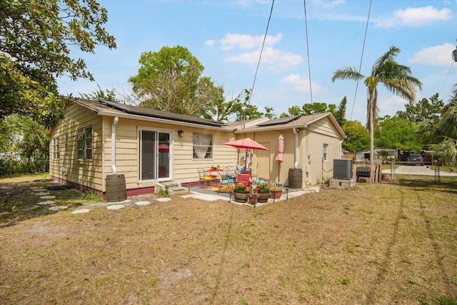 5050 68th Way N, Saint Petersburg, FL 33709 - rear view of property featuring solar panels and a patio area