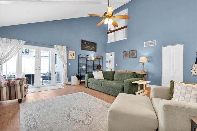living room with high vaulted ceiling, a ceiling fan, wood finished floors, french doors, and visible vents