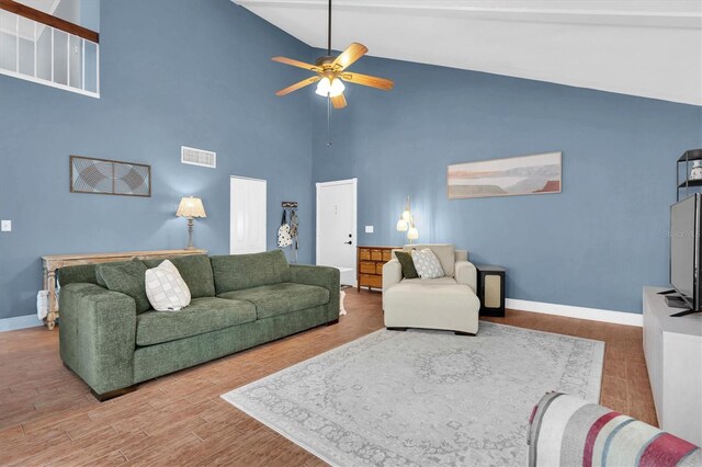 living room with high vaulted ceiling, ceiling fan, wood finished floors, and visible vents