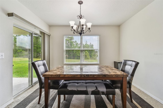 6882 Silverado Ranch Blvd, Zephyrhills, FL 33541 - carpeted dining space featuring baseboards, a wealth of natural light, and a notable chandelier