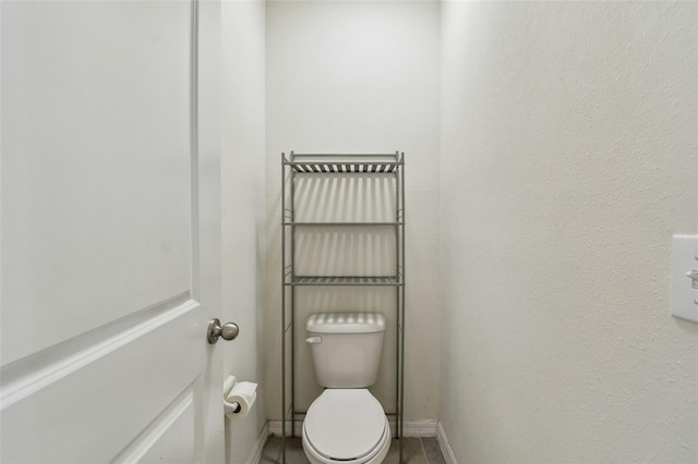 6882 Silverado Ranch Blvd, Zephyrhills, FL 33541 - bathroom featuring baseboards, tile patterned flooring, and toilet