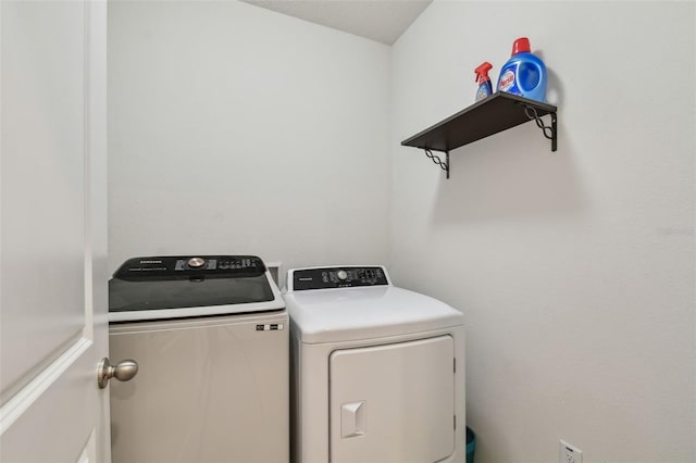 6882 Silverado Ranch Blvd, Zephyrhills, FL 33541 - laundry area with washing machine and clothes dryer and laundry area
