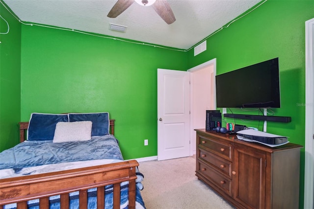 6882 Silverado Ranch Blvd, Zephyrhills, FL 33541 - bedroom with light carpet, a ceiling fan, visible vents, and a textured ceiling