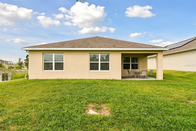 6882 Silverado Ranch Blvd, Zephyrhills, FL 33541 - rear view of house with stucco siding, a lawn, and a patio