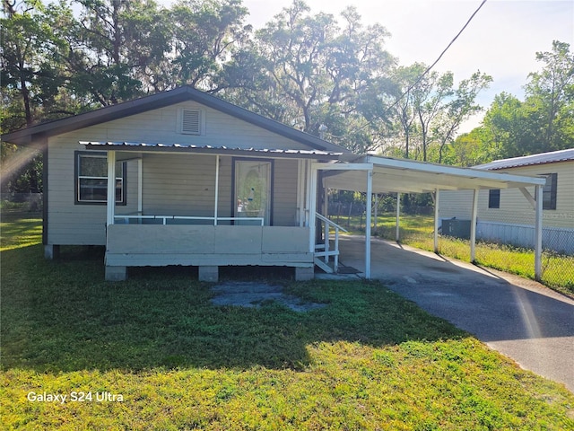 851 Easy St, Brooksville, FL 34601 - manufactured / mobile home with covered porch, an attached carport, concrete driveway, and a front lawn