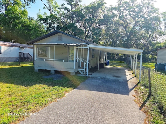 851 Easy St, Brooksville, FL 34601 - manufactured / mobile home featuring driveway, an attached carport, a front lawn, and a porch