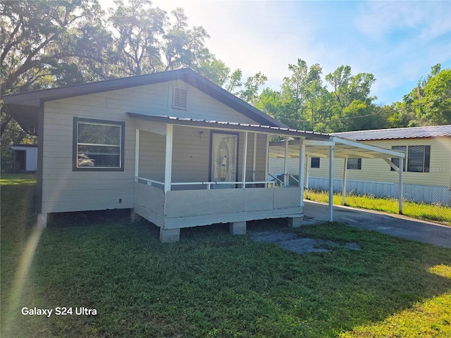 851 Easy St, Brooksville, FL 34601 - manufactured / mobile home with a front lawn, metal roof, a carport, and a sunroom