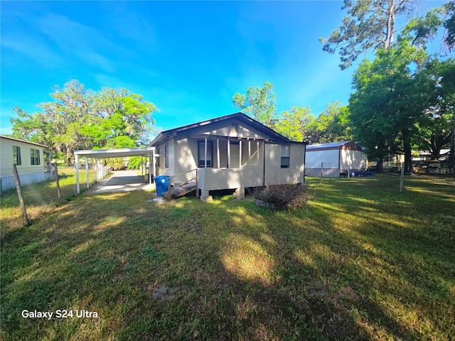 851 Easy St, Brooksville, FL 34601 - rear view of house featuring a yard, a carport, and fence