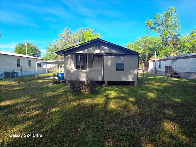 851 Easy St, Brooksville, FL 34601 - back of house featuring fence, a yard, and a carport