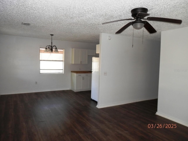 851 Easy St, Brooksville, FL 34601 - unfurnished living room with ceiling fan with notable chandelier, visible vents, dark wood-type flooring, and a textured ceiling