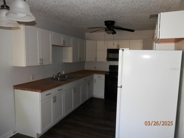 851 Easy St, Brooksville, FL 34601 - kitchen featuring dark wood-style flooring, a sink, visible vents, a ceiling fan, and black appliances