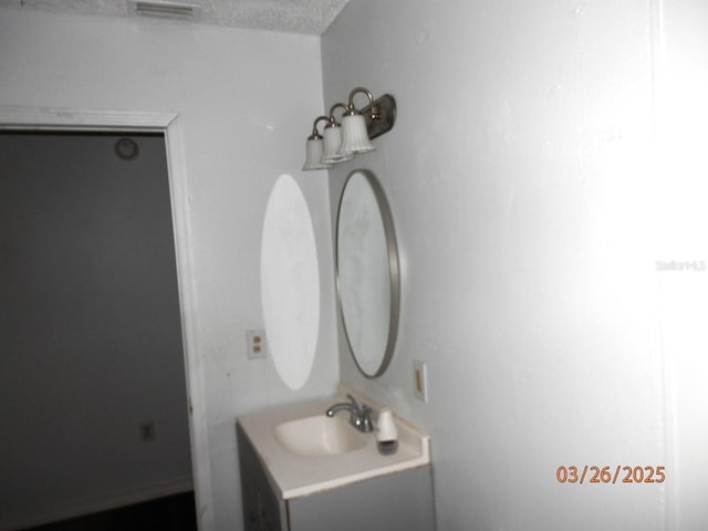 851 Easy St, Brooksville, FL 34601 - bathroom featuring a textured ceiling, visible vents, and vanity