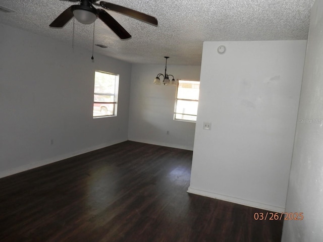 851 Easy St, Brooksville, FL 34601 - spare room featuring dark wood finished floors, ceiling fan with notable chandelier, a textured ceiling, and a healthy amount of sunlight