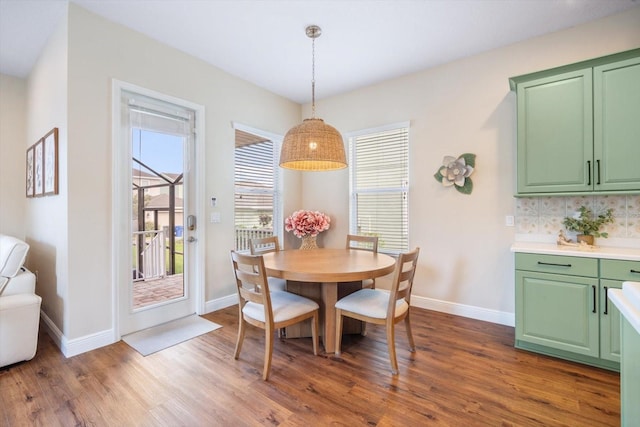dining space with baseboards and dark wood-style floors