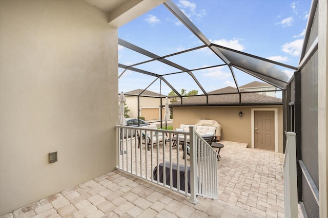 view of patio with glass enclosure