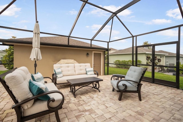 view of patio with glass enclosure and an outdoor living space