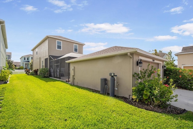11109 Great Neck Rd, Riverview, FL 33578 - back of property featuring stucco siding, an attached garage, a lawn, and glass enclosure