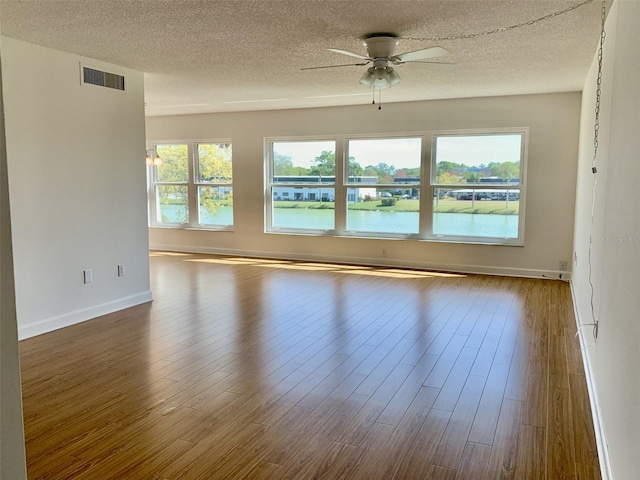 1655 S Highland Ave Unit I286, Clearwater, FL 33756 - spare room with ceiling fan, a textured ceiling, dark wood-style floors, and baseboards