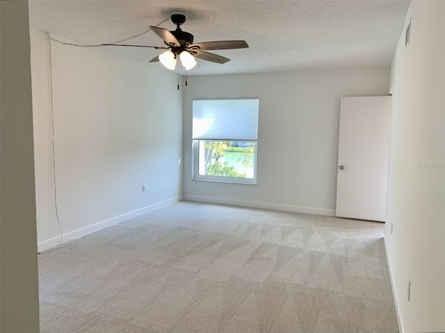 1655 S Highland Ave Unit I286, Clearwater, FL 33756 - empty room featuring light carpet, a ceiling fan, baseboards, and a textured ceiling