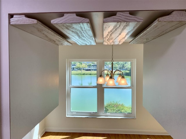 1655 S Highland Ave Unit I286, Clearwater, FL 33756 - detailed view of baseboards, a chandelier, and wood finished floors