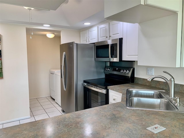 1655 S Highland Ave Unit I286, Clearwater, FL 33756 - kitchen featuring electric range, separate washer and dryer, a sink, stainless steel microwave, and light tile patterned floors
