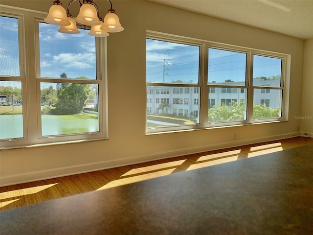 1655 S Highland Ave Unit I286, Clearwater, FL 33756 - spare room with a chandelier, baseboards, and wood finished floors