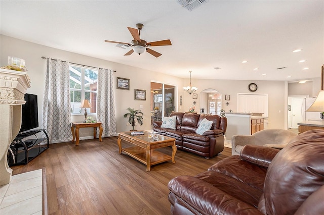 living room featuring recessed lighting, ceiling fan with notable chandelier, light wood finished floors, and visible vents