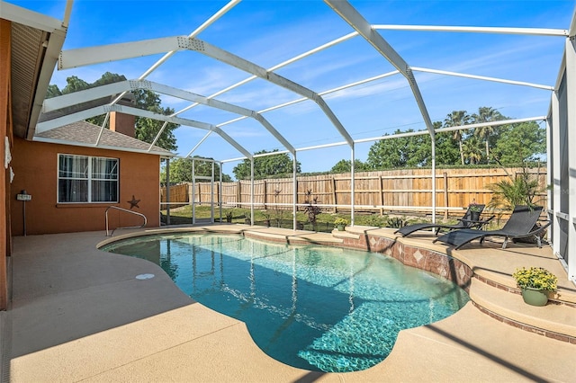 view of swimming pool featuring a fenced in pool, a lanai, a fenced backyard, and a patio area