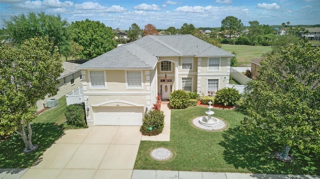 13122 Prestwick Dr, Riverview, FL 33579 - view of front facade with stucco siding, a front yard, fence, an attached garage, and concrete driveway