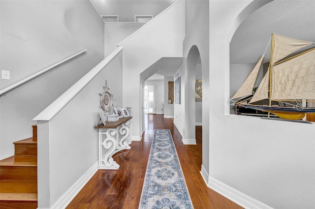 13122 Prestwick Dr, Riverview, FL 33579 - hall with arched walkways, wood finished floors, baseboards, and stairs