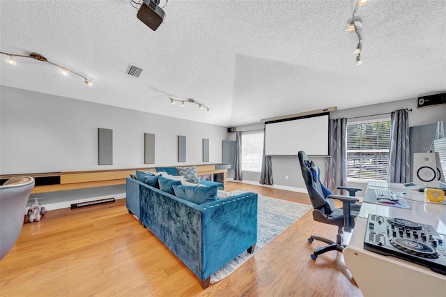 13122 Prestwick Dr, Riverview, FL 33579 - home office with visible vents, a textured ceiling, and wood finished floors