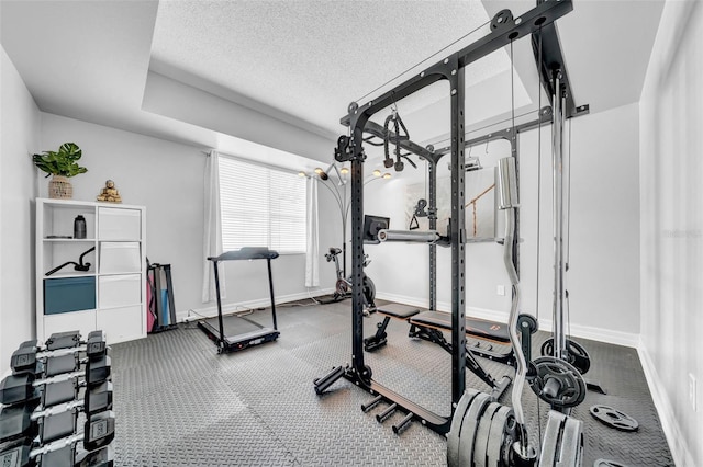 13122 Prestwick Dr, Riverview, FL 33579 - workout room featuring a textured ceiling and baseboards
