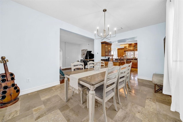 13122 Prestwick Dr, Riverview, FL 33579 - dining area with a chandelier, baseboards, and stone finish flooring