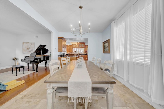 13122 Prestwick Dr, Riverview, FL 33579 - dining area featuring a chandelier, light wood-type flooring, and baseboards