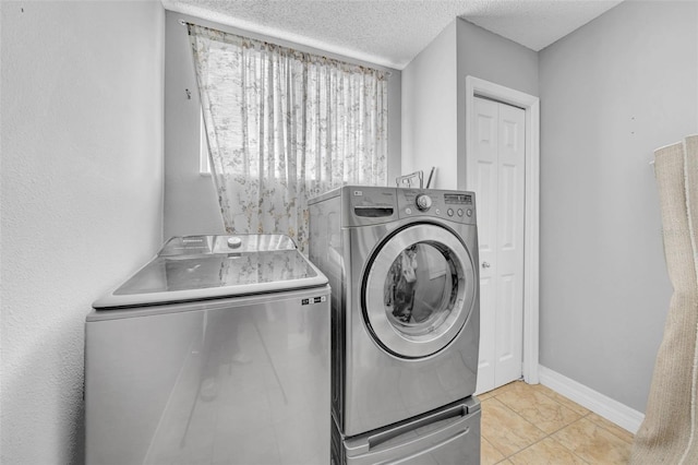 13122 Prestwick Dr, Riverview, FL 33579 - clothes washing area featuring baseboards, washer and dryer, laundry area, and a textured ceiling