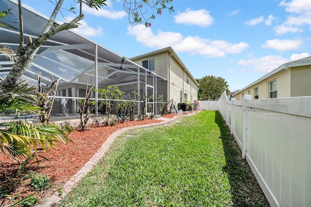 13122 Prestwick Dr, Riverview, FL 33579 - view of yard featuring a fenced backyard, central AC, and a lanai