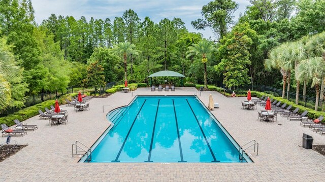 8247 Westhaven Dr, Land O Lakes, FL 34638 - community pool featuring view of wooded area and a patio
