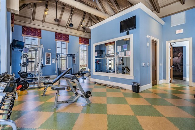 8247 Westhaven Dr, Land O Lakes, FL 34638 - gym with high vaulted ceiling, baseboards, wooden ceiling with exposed beams, and tile patterned floors