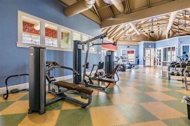 8247 Westhaven Dr, Land O Lakes, FL 34638 - workout area featuring baseboards, beam ceiling, high vaulted ceiling, and tile patterned floors