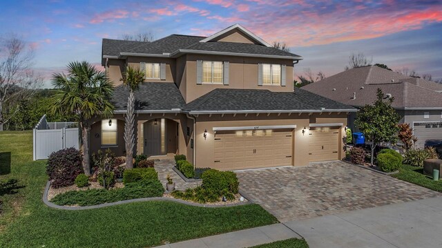 8247 Westhaven Dr, Land O Lakes, FL 34638 - traditional-style house featuring stucco siding, decorative driveway, and a shingled roof