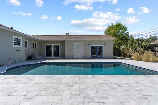 outdoor pool featuring a patio and french doors