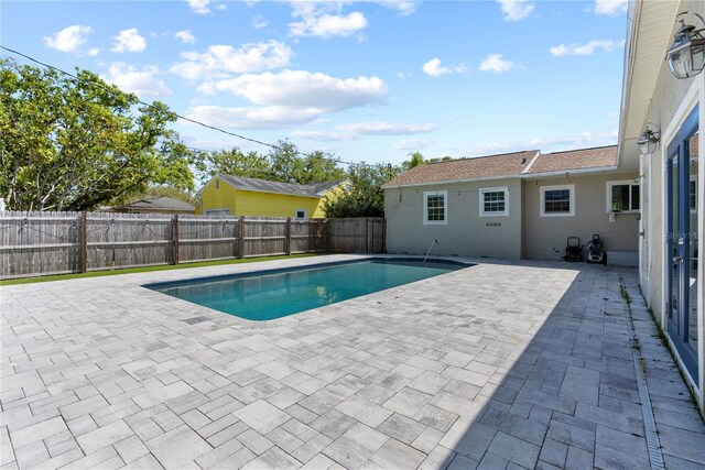 view of swimming pool featuring a fenced in pool, a patio, and a fenced backyard
