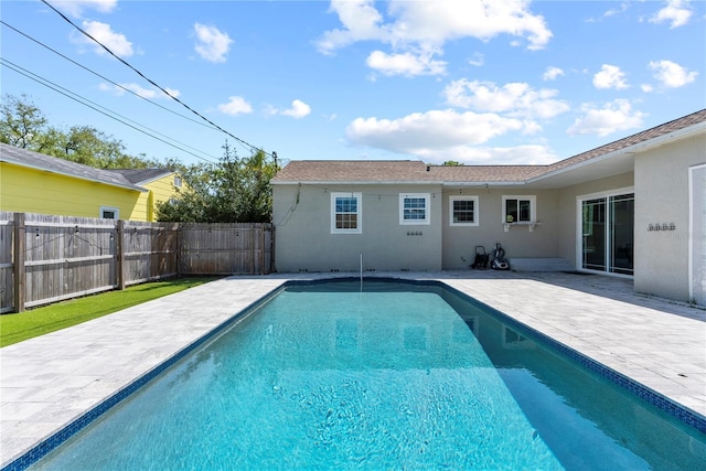 view of swimming pool featuring a patio area and fence