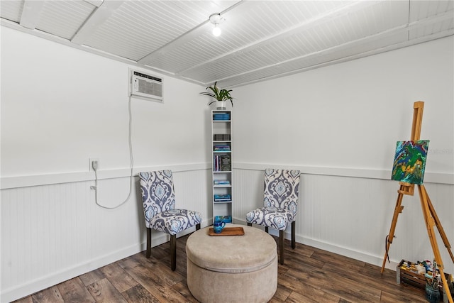 living area featuring a wainscoted wall, a wall mounted AC, and wood finished floors