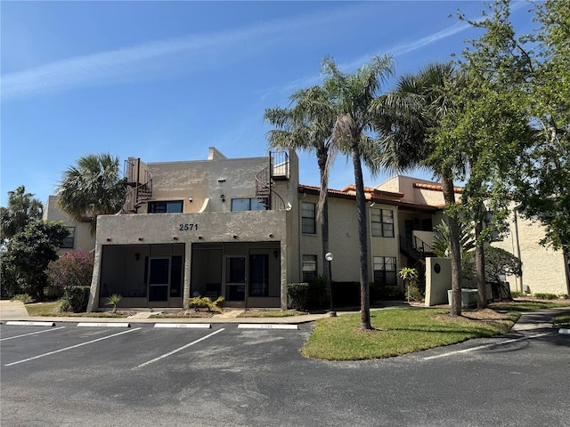2571 Cyprus Dr Unit 1-102, Palm Harbor, FL 34684 - view of property featuring uncovered parking